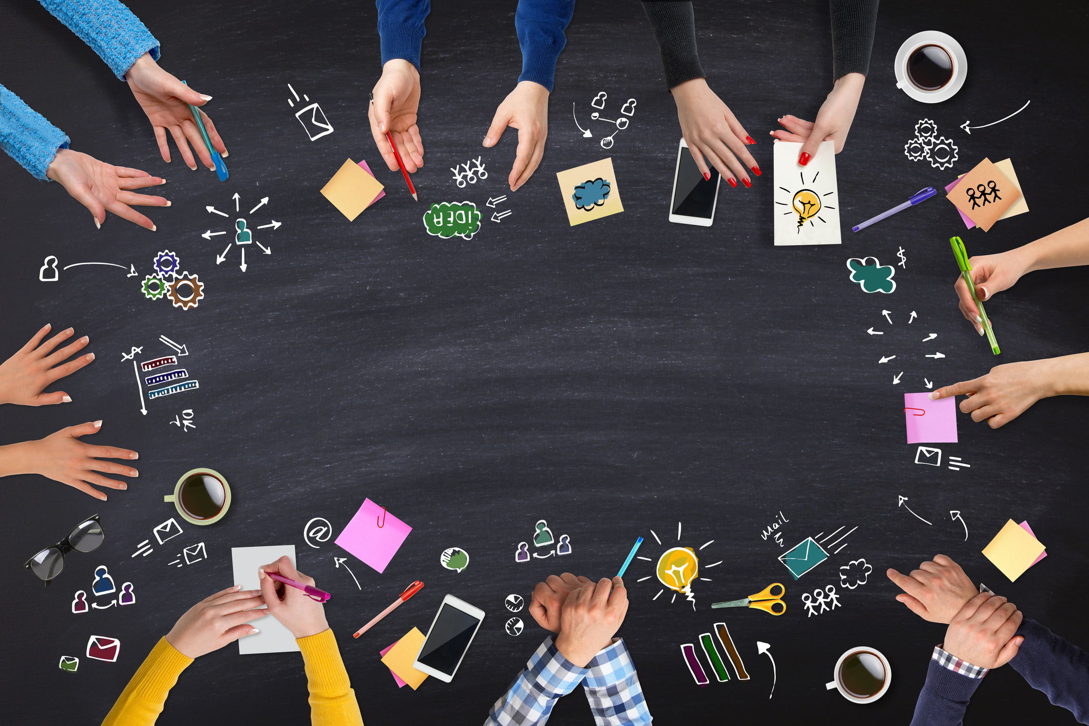 Diverse humans hands in a circle with various writing and communication instruments as well as doodles, formulas, maths, icons, and more expressing engaged and dynamic dialogue together.